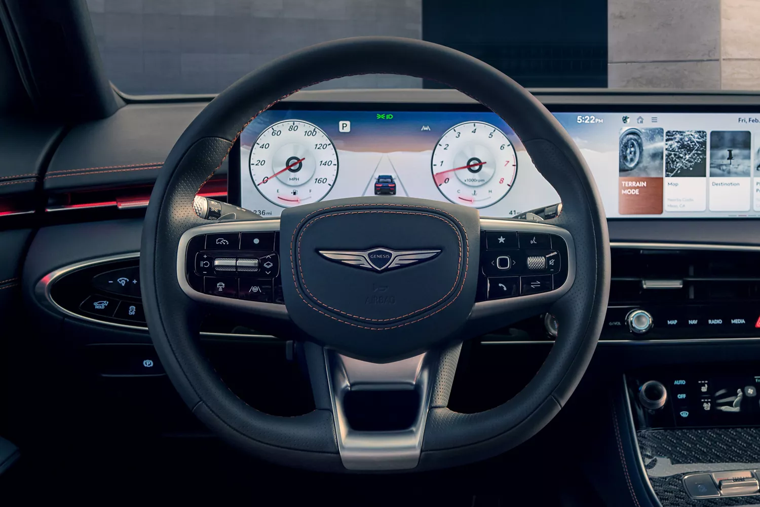 A modern car's dashboard with a steering wheel in the foreground. The digital screen behind the wheel shows gauges and a small car on a road.
